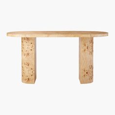 an oval wooden table with two legs on the top and one leg in the middle