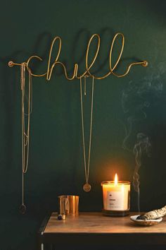 a candle and some necklaces on a table