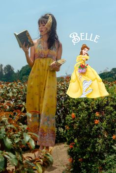 a woman in a yellow dress reading a book next to a statue of a princess