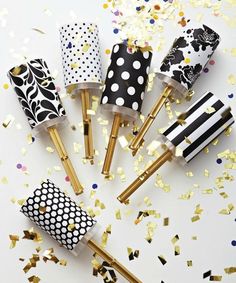 five black and white polka dot party straws with gold confetti on them