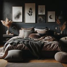 a bed with pillows and blankets in a room next to pictures on the wall above it