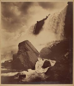 an old black and white photo of waves crashing over rocks