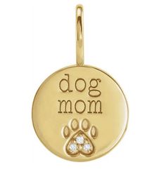 a gold plated dog mom charm with a paw print on the front and bottom