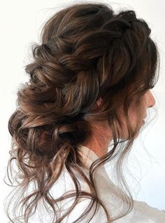 a woman with long hair in a messy updo