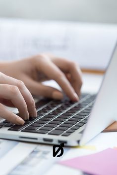 a person typing on a laptop with their hands