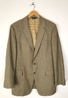 "-Description- >men's brown pinstriped sport coat >two button front >three buttons on the cuffs >two flap close and one open pocket on the front >vent in the back >partially lined >size 44 - no size tag, size is based on measurements - please check all measurements before purchase >so classy! >condition: very good >color(s): brown, blue >fabric(s): wool >care: dry clean -Measurements- >size: 44 - no size tag, size is based on measurements - please check all Classic Striped Suits With Pockets, Striped Business Casual Blazer With Pockets, Striped Blazer With Pockets For Business Casual, Classic Striped Sport Coat With Welt Pockets, Business Striped Sport Coat With Welt Pockets, Striped Sport Coat With Welt Pockets For Business, Classic Striped Sport Coat For Business, Pinstripe Single Breasted Long Sleeve Sport Coat, Pinstripe Single-breasted Long Sleeve Sport Coat