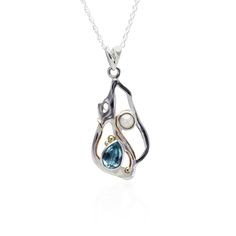 "Our Sterling Silver Blue Topaz and Freshwater Pearl Pendant Necklace is an elegant and enchanting gift for her. A beautiful teardrop blue topaz and freshwater pearl are set on a beautifully handcrafted silver pendant. Finished with dainty 14kt Gold and brass pip detailing. This pendant comes on an 18\" round light link chain with a spring-ring clasp. If you are searching for meaningful birthstone gifts or an elegant anniversary gift, this is the perfect gift for her. Pearl is the birthstone for Opal Necklace Silver, Silver Crown Ring, Signature Bracelet, Signature Necklace, Opal Pendant Necklace, Round Light, Topaz Necklace, Freshwater Pearl Necklace, Necklace Unique