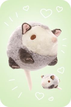 a stuffed animal is sitting on top of a stick with two smaller animals in front of it