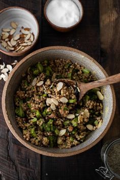 a bowl filled with rice, broccoli and almonds