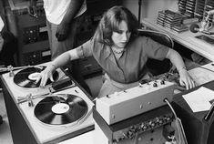 a woman in a room with record players