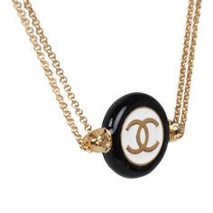 This Chanel round CC enamel pendant choker necklace with gold tone metal hardware features a small round black and white enamel and gold tone pendant and an adjustable doubled chainlink necklace and a lobster clasp closure.Origin: Italy Series: 24PCondition: New and never wornAccompanied by: Chanel box, pouch, felt, carebook and retail UPCMeasurements: length (circumference) : 15"; diameter: 6.5"; round pendant .75" x .75" Luxury White Enamel Necklace, Classic Black Jewelry With Logo Charm, Luxury Black Necklace With Logo Charm, Black Metal Jewelry With Logo Charm, Classic Black Jewelry With Gold Chain, Choker Necklace Black, Pendant Choker Necklace, Chanel Box, Box Pouch