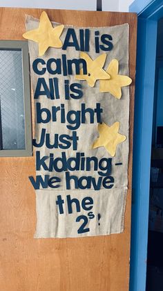 a bulletin board with words written on it in front of a blue door that says, all is calm and all is bright just koding we have the 2