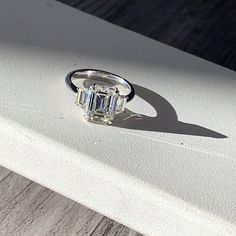 a diamond ring sitting on top of a piece of paper