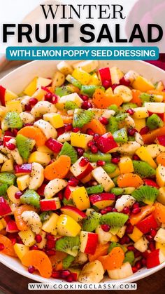 a white bowl filled with fruit salad on top of a wooden table and text overlay reads winter fruit salad with lemon poppy seed dressing