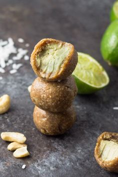 some food is stacked on top of each other with nuts and avocado in the background