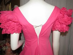 "Maybe 60's/70's lovely pink ruffle-listic dress, ankle-length, by Creaciones, in a size 7/C. Great Quinceanera celebration wear, with V-neck-off shouldered fitted bodice, huge ruffled 4 layered sleeves, and the skirt part is tapered at the waist, with and 8 layered ruffled skirt. The dress has a nylon back zipper closure, and in photo 6 & 7, is not zipped all the way to the top/back, because my mannequin is a slight too large for it. Dress is of cotton fabric, and is a little weighty from s Pink Summer Dress For Vintage Fashion, Pink Summer Dress For Vintage Occasions, Pink Vintage Dress For Summer Party, Retro Pink Dresses With Ruffles, Retro Pink Ruffled Dresses, Pink Retro Dresses With Ruffles, Pink Retro Dress With Ruffles, Fitted Pink Vintage Dress With Ruffles, Fitted Pink Vintage Dress For Spring