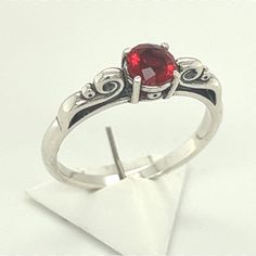 Bixbite Silver Ring, Custom Faceted Red Beryl, 5 MM Synthetic Gemstone, Twist Design Sterling Silver Ring Gorgeous, Super Rare Red Bixbite Gemstone,  I prong set this beauty into a Twist Design Sterling Silver ring.   Ron custom faceted this Boxbite gemstone into a beautiful round brilliant. Ring sizes 6  Bixbite is Red Beryl.   Lab created Bixbite that has the same physical, optical and chemical properties as the mined gemstone. Stamped inside shank, .925 Materials used to make this Custom Ring Classic Adjustable Red Ring, Adjustable Red Birthstone Promise Ring, Red Ruby Birthstone Ring With Round Stone, Red Birthstone Ring With Round Stone For Gift, Red Crystal Ring With Stone Setting For Promise, Classic Red Gemstone Crystal Ring, Red Crystal Promise Ring With Stone Setting, Adjustable Red Gemstone Birthstone Ring, Vintage Red Crystal Round Ring