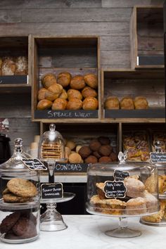 an assortment of baked goods on display in a bakery