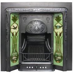 an ornate fireplace with green and black tiles