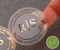 a person is holding up a silver and gold coin with the word r s on it