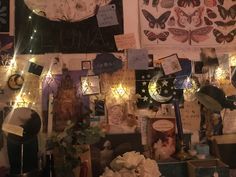 a wall covered in lots of different types of decorations and pictures with lights on them