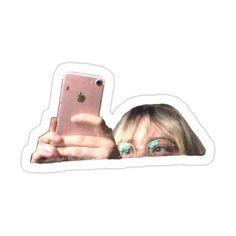 a woman taking a selfie with her cell phone in front of her sticker