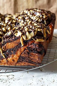 a loaf of chocolate cake on a cooling rack