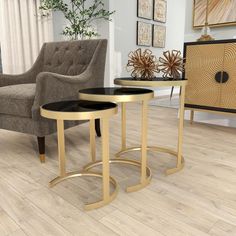 two tables sitting on top of a hard wood floor next to a chair and table