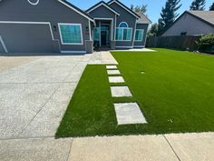 a house that has grass in the front yard and walkways on the side of it