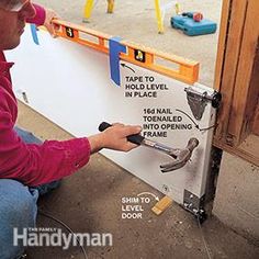 a man working on a sign with tools