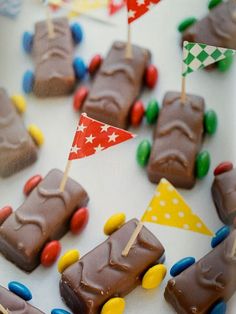 chocolate cars and flags are arranged on a table