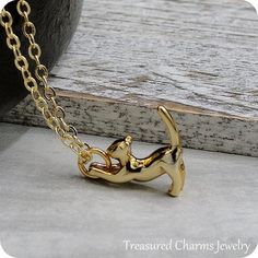 This Stretching Cat Charm necklace comes on a gold-plated chain that is available in different lengths. Please choose your desired length from the drop-down menu when placing the item in your shopping cart. { CHARM DETAILS }★ Material: Pewter ★ Finish Color: Gold★ Measurements: 5/8" x 3/4"★ Dimensions: 3-Dimensional{ SIMILAR ITEMS } More cat and pet themed items available from my shop: https://www.etsy.com/shop/treasuredcharms/search?search_query=animal+rescue{ GIFT OPTIONS}Gift boxes are availa Gold Charm Necklace With Cat Design For Gift, Gold Dangle Cat Design Jewelry, Elegant Pendant Necklace With Cat Design, Cat Necklace Gold, Crazy Cat Lady Gifts, Gold Sterling Silver Necklace With Cat Design, Cat Charm Necklace, Cat Lady Gift, Pandora Beads