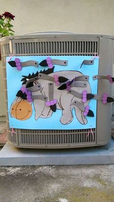 an elephant painted on the side of a television screen with flowers in front of it