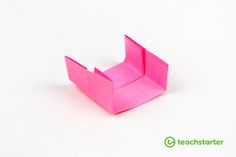 a pink origami box sitting on top of a white table