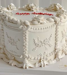 a large white cake sitting on top of a table