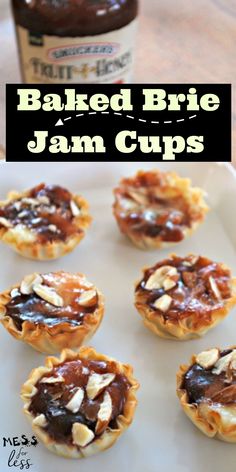 baked brie and jam cups on a baking sheet with peanut butter in the background