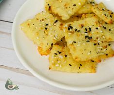 some food on a white plate with sesame seeds