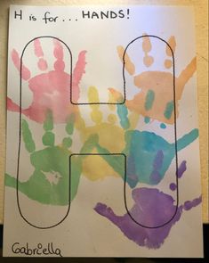 the letter h is for hands made with handprints and watercolors on paper