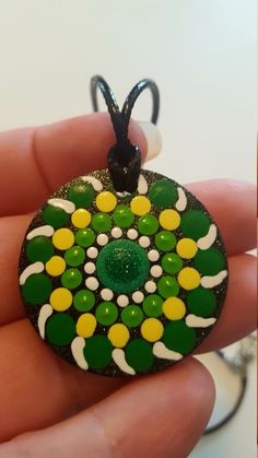 This vibrant pendant is hand-painted/ hand-dotted. The pendant is wooden and light weight. It measures 1.5inches and is .125inches thick. It is covered in a green/gold sparkle dragonfly glaze with a hand-painted mandala in shades of green, yellow and white. It has also been sealed. The cord is a black waxed cord that is 20 inches in length with a 2inch extension chain. The necklace is adjustable with a lobster claw clasp. The necklace will come in a white organza bag. Would make an awesome stock Green Hand Painted Necklace For Gift, Mandala Jewelry, Hand Painted Necklace, Pendants For Women, Painted Mandala, Stone Art Painting, Women Necklaces, Art Pendant, Women Gifts