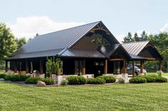 a large house with a metal roof in the middle of a field