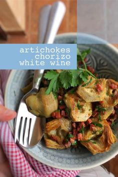 a person holding a plate with artichokes and white wine