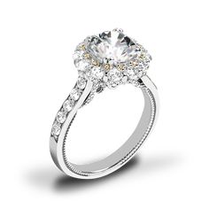 a diamond engagement ring with two tone gold and white diamonds on the band, set in 18k white gold