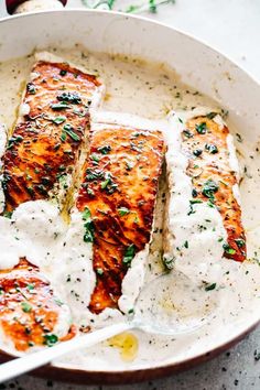 a pan filled with fish covered in sauce and garnished with parmesan