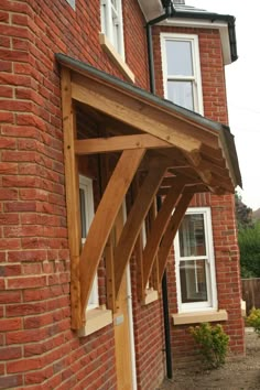 a wooden porch attached to a brick building