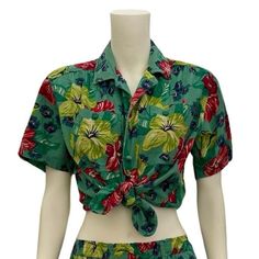 This bold 1980s green floral print top is part of a matching play set from Liz Wear by Liz Claiborne. I'm listing the pieces separately as not everyone wants a completely matching outfit. The top is 100% cotton and tagged a size small, but it is typical boxy oversized 80s top, so it's bigger in the bust and waist, but short - see measurements for details. It has removeable shoulder pads (velcro), buttons up the front with double buttons (two at each button hole spot) and has two large pockets on Hawaiian Cotton Floral Print Tops, Green Floral Print Short Sleeve Top, Vintage Floral Print Sets For Spring, Beach Green Floral Print Set, Beach Green Floral Print Sets, Retro Cotton Top With Tropical Print, Retro Cotton Tops With Tropical Print, 90s Floral Print Summer Tops, 90s Style Floral Print Summer Tops