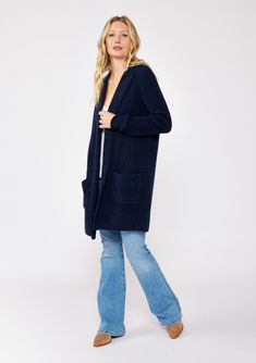 An ultra warm and cozy mid-length hooded cardigan in navy. Fuzzy texture Relaxed fit Long sleeve Mid-length Hooded Open front Patch pockets Women's fall cardigan Dry clean only Embrace all the cozy vibes in this ultra-soft long cardigan - your new Fall favorite! This versatile layering piece features an open front, a comfy hoodie, long sleeves, and convenient patch pockets. You'll find yourself reaching for this easy fit style all season long. Model is 5'7.5, wearing a size S.Style: I-51072K-SLQ Comfy Soft-texture Fall Outerwear, Comfy Soft Knit Outerwear For Cold Weather, Cozy Long Sweater Coat With Pockets, Comfy Soft Knit Long Sleeve Outerwear, Winter Loungewear Sweater Coat With Soft Texture, Blue Winter Sweater Coat With Pockets, Cozy Open Front Sweater Coat For Cold Weather, Cozy Long Outerwear With Pockets, Cozy Sweater Coat With Pockets