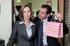 a man and woman dressed in business attire holding shopping bags