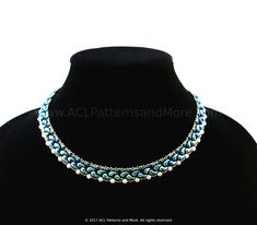 a blue and white beaded necklace on a mannequinl neckpiece with pearls