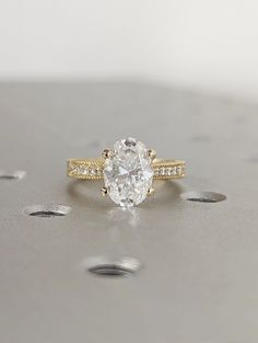 ✥ Introducing the enchanting 2.0CT Oval Lab Grown Diamond Engagement Ring, a perfect vintage promise ring for the modern romantic. This exquisite piece features a stunning oval lab-grown diamond that radiates brilliance and elegance, capturing the essence of timeless beauty. The vintage-inspired design adds a touch of nostalgia, making it an ideal choice for those who cherish classic styles. The delicate band enhances the diamond's allure, ensuring it stands out beautifully. We have options of 2.50ct & 3.0ct available, and if you need any carat sizes, please contact us for personalized assistance. Celebrate your love with this captivating ring that symbolizes your everlasting commitment. "Enhance your eco-friendly journey with conflict-free, timeless handmade lab-grown diamonds." ✦ Main St Vintage Promise Ring, Engagement Ring Types, Milgrain Engagement Ring, Engagement Ring Custom, Promise Rings Vintage, Vintage Inspired Rings, Lab Grown Diamond Engagement Ring, Diamond Engagement Rings Vintage, Lab Diamond Engagement Ring