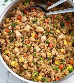 a pot filled with rice and vegetables on top of a table